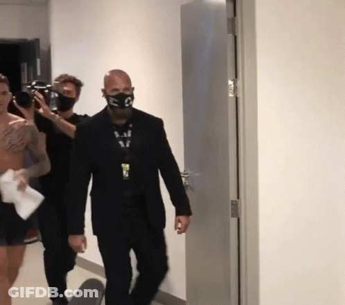 Man With S Mask Walking Hallway GIF