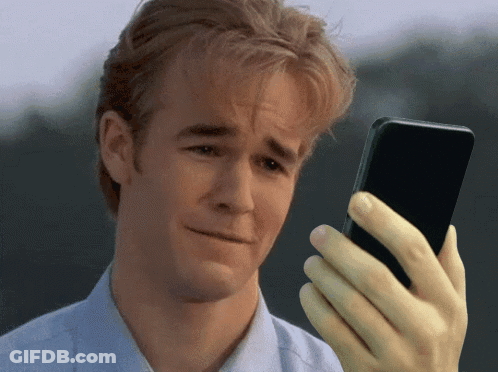 Man With Sad Look Holding Cellphone GIF