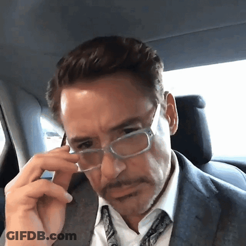 Man With Sarcastic Smile Looking At Another Man GIF