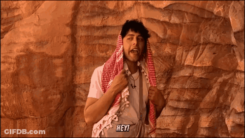 Man With Scarf Around Head Saying Hey GIF