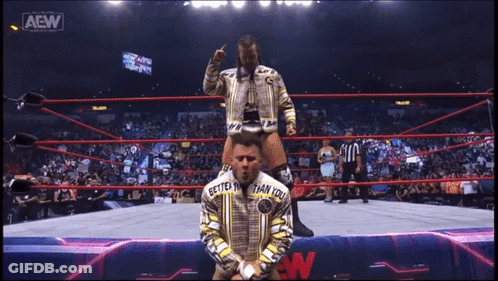 Man With Scarf At All Elite Wrestling Sign GIF