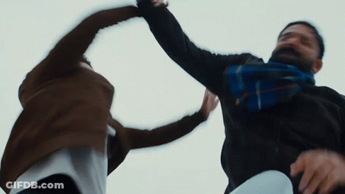 Man With Scarf Holding Another's Arm GIF