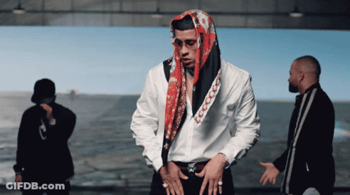 Man With Scarf In Front Of Two Men GIF