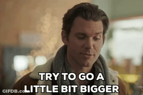 Man With Scarf Saying Try To Go A Little Bit Bigger GIF