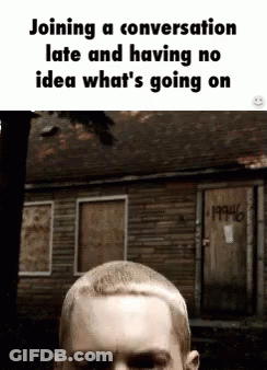 Man With Shaved Head In Front Of Graffiti GIF