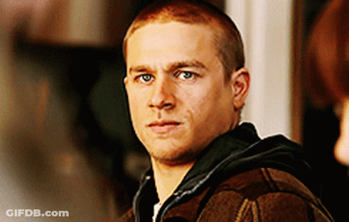 Man With Shaved Head In Plaid Jacket And Black Hoodie GIF