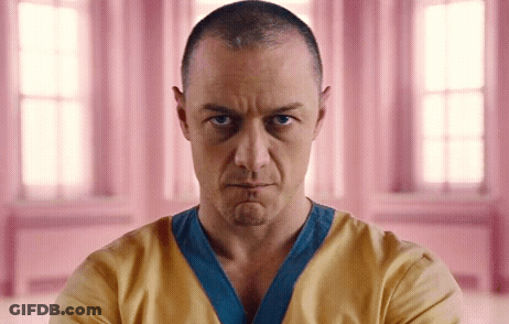 Man With Shaved Head In Yellow And Blue Shirt GIF