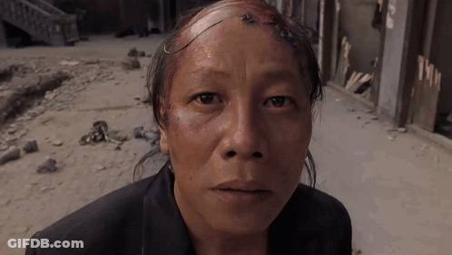 Man With Shaved Head Looking At Camera GIF