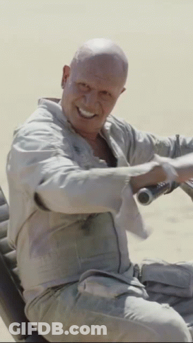 Man With Shaved Head Smiling Holding Steering Wheel GIF