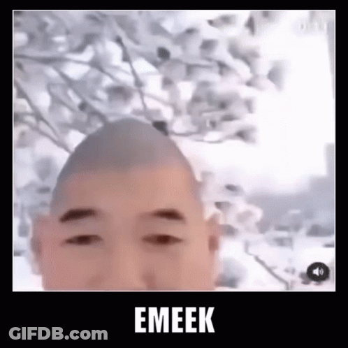 Man With Shaved Head Standing In Front Of Tree GIF