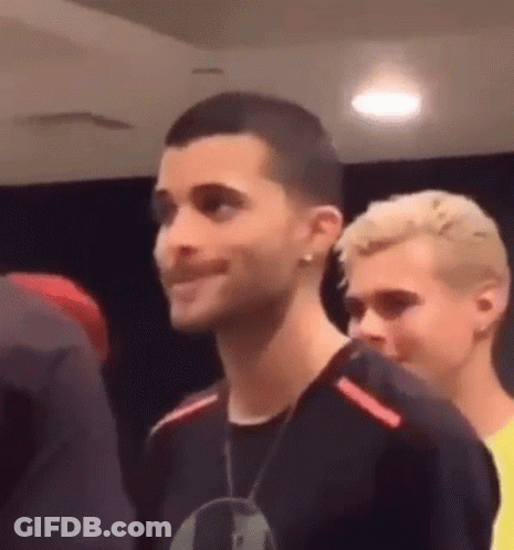 Man With Shaved Head Standing Next To Another GIF