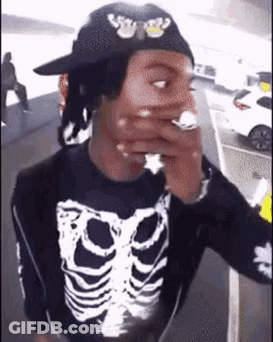 Man With Skeleton Shirt And Hat Smoking Cigarette GIF