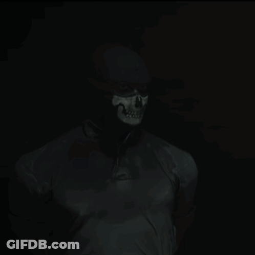 Man With Skull Painted Face In Dark GIF