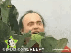 Man With Star On Head Holding Plant Saying Creepy GIF