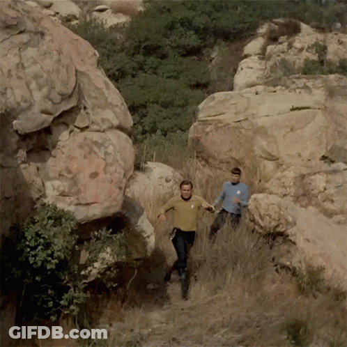 Man With Star Trek Logo Running Down Trail GIF