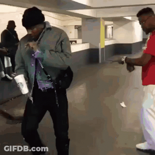 Man With Starbucks Cup On Shoulder Talking To Another Man GIF