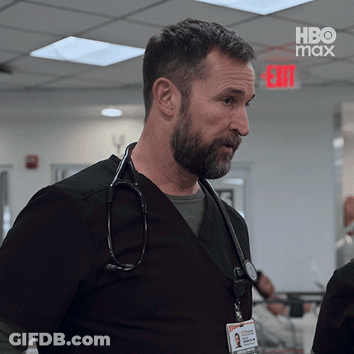 Man With Stethoscope In Front Of Exit Sign GIF