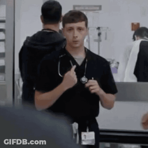 Man With Stethoscope Standing Next To Another Man GIF
