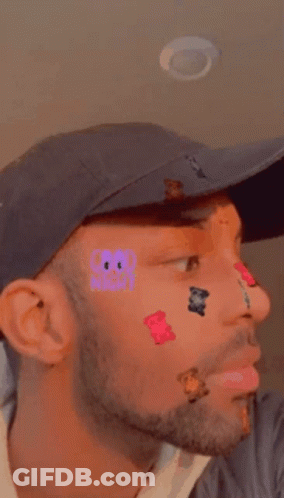 Man With Stickers On Face Wearing Hat GIF