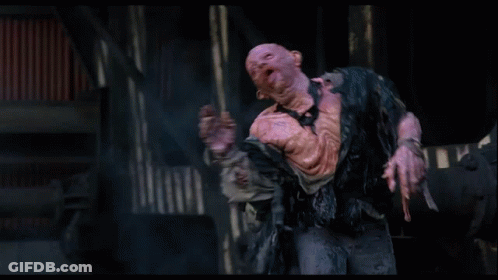 Man With Strange Face Standing In Dark Room Hands Outstretched GIF