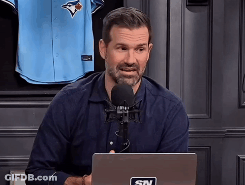 Man With STV Sticker On Laptop At Microphone GIF