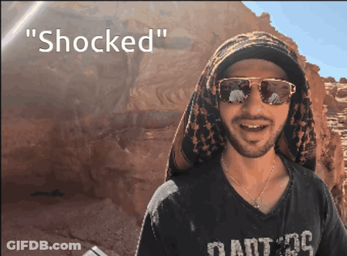 Man With Sunglasses And Scarf Says Shocked GIF
