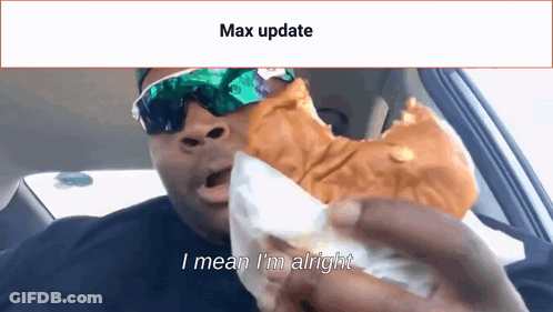 Man With Sunglasses Eating Sandwich In Car Says Max Update GIF