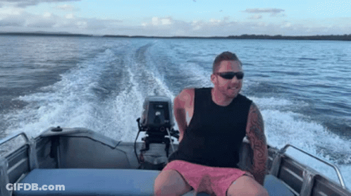 Man With Sunglasses Sitting On Boat GIF