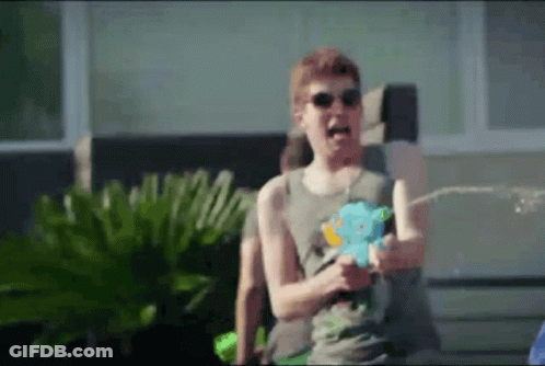 Man With Sunglasses Spraying Water Gun GIF