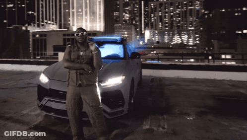 Man With Sunglasses Standing By Car In Parking Lot GIF