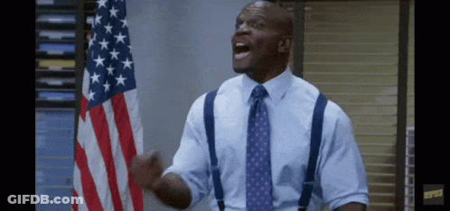 Man With Suspenders And Tie In Front Of American Flag GIF