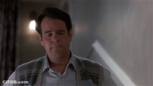 Man With Sweater Around Neck Looking At Something GIF