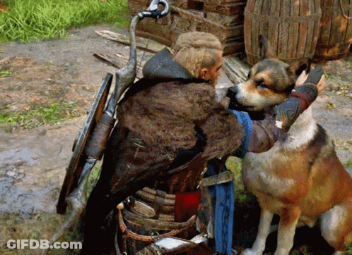Man With Sword And Shield Next To Brown And White Dog GIF