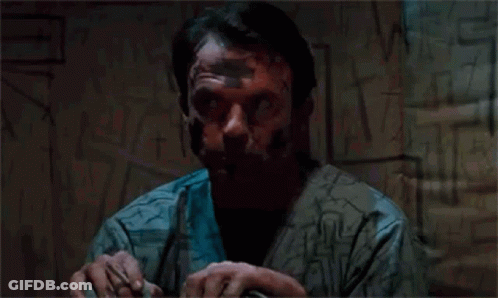 Man With Tape On Face By Graffiti Wall GIF