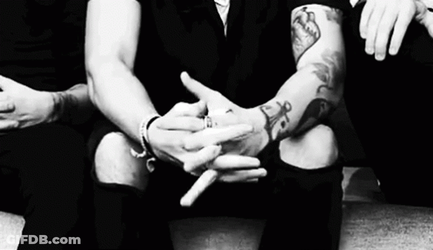 Man With Tattoo Cracking Knuckles GIF