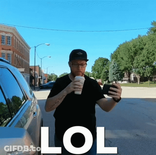 Man With Tattoo Drinking Coffee Looking At Phone GIF