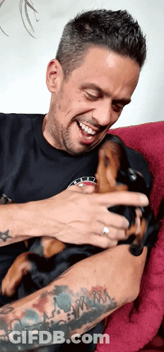 Man With Tattoo Holding Puppy GIF