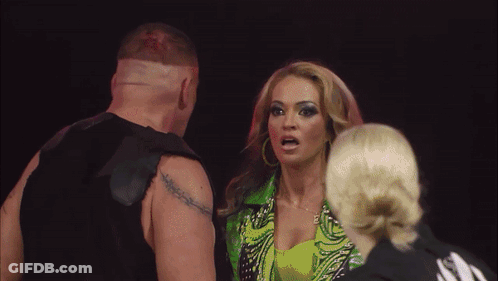 Man With Tattoo Next To Woman In Green Outfit GIF