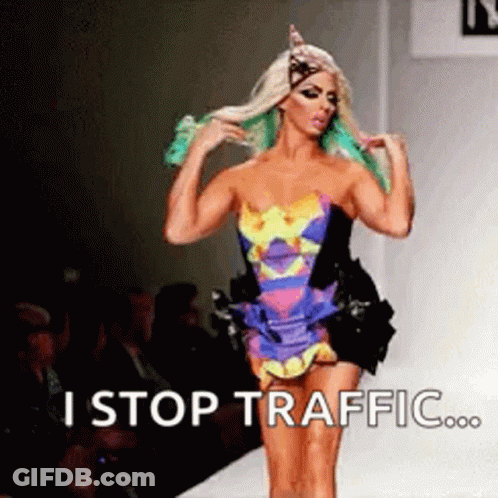 Man With Tattoo Next To Woman In Green Outfit GIF