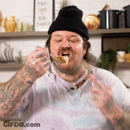 Man With Tattoo On Arm Eating Food GIF