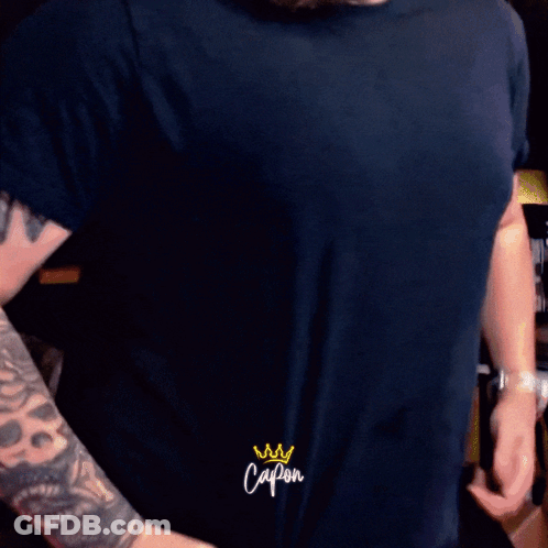 Man With Tattoo On Arm Saying Capon On Sleeve GIF