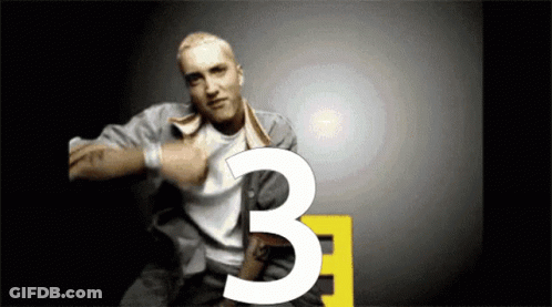 Man With Tattoo Pointing To Number Three GIF