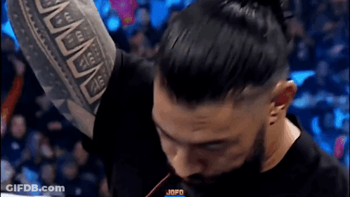 Man With Tattoo Raising Arm GIF