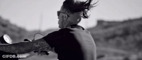 Man With Tattoo Riding Motorcycle On Road GIF