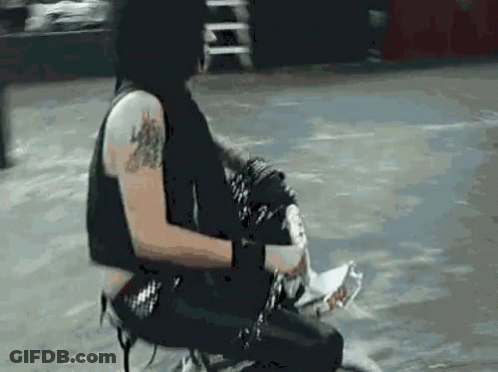 Man With Tattoo Sitting On Stool GIF