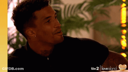 Man With Tattoo Smiling In Love Island Ad GIF