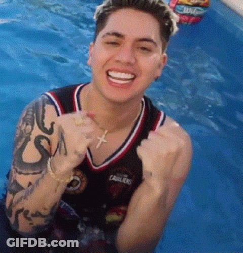 Man With Tattoo Smiling In Pool GIF