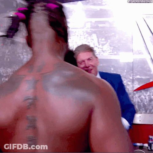 Man With Tattoo Talking To Suit GIF