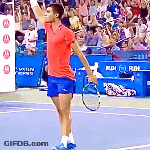 Man With Tennis Racquet In Front Of Hotel & Resorts Sign GIF