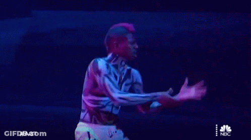 Man With Tiger Body Paint Holding Sword On Stage GIF